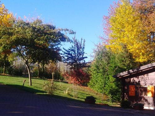 a building in a park with trees and grass at CAMPING IL MELO in Peveragno