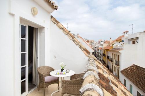 balkon ze stołem i krzesłami w budynku w obiekcie Hotel Marbella w mieście Fuengirola