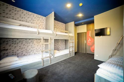 a room with two bunk beds and a television at Olympic - Old Town in Gdańsk