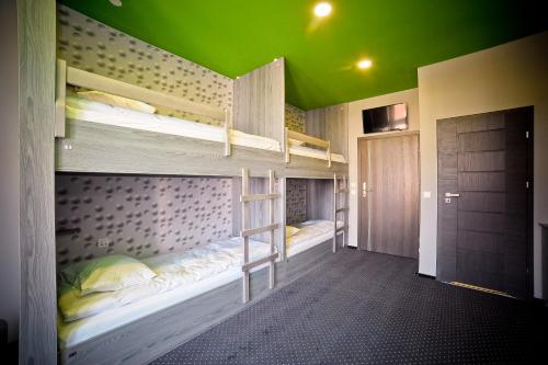 two bunk beds in a room with a green ceiling at Olympic - Old Town in Gdańsk
