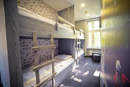 two bunk beds in a room with a window at Olympic - Old Town in Gdańsk
