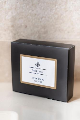 a box of scented candles sitting on a table at Hôtel Le Presbytère in Paris