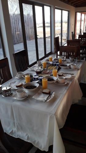 a long white table with food and drinks on it at Willy's Country Club Cauquenes in De Cauquenes