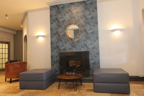 a living room filled with furniture and a fire place at Gwesty Nanhoron Arms Hotel in Nefyn