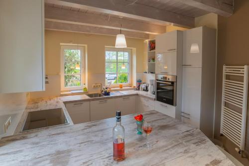 a kitchen with a bottle of wine on a counter at Künstlerhaus in Rieseby