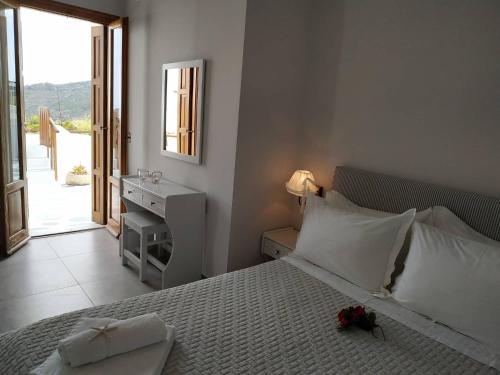 a bedroom with a bed with a flower on it at Andreas and Petrinela Rooms in Triovasálos