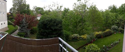 a view of a garden with a fence and trees at Garzon in Budapest