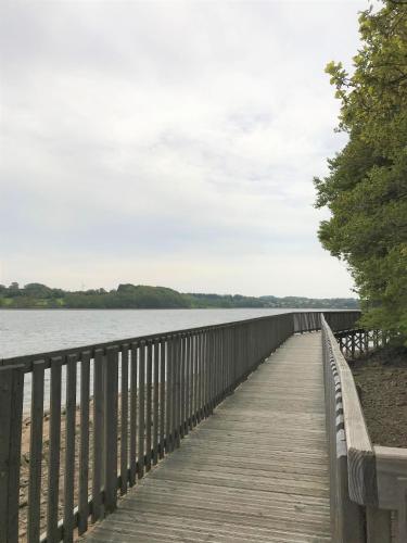 a wooden bridge over a body of water at Village Vacances Yaloer in Villefranche-de-Panat