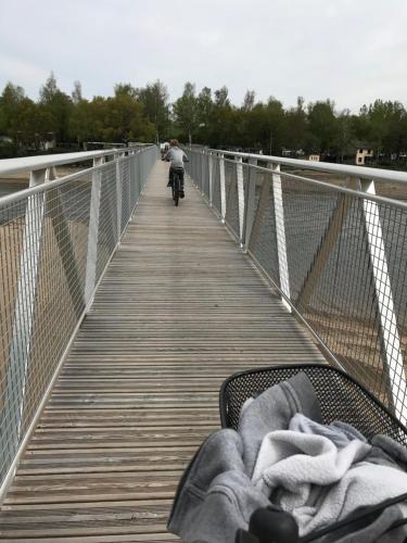 a person riding a bike on a bridge at Village Vacances Yaloer in Villefranche-de-Panat