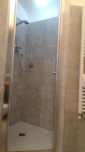 a shower with a glass door in a bathroom at Il Vicolo - Affittacamere in Ruvo di Puglia