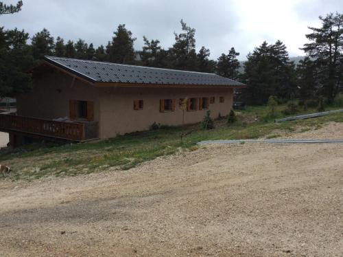 a small house on a hill next to a dirt road at Le Cytise in Caille