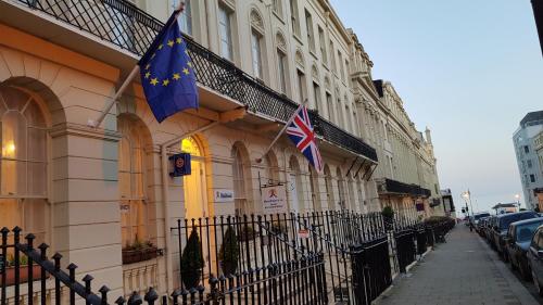 two british flags on the side of a building at Andorra Guest Accommodation in Brighton & Hove