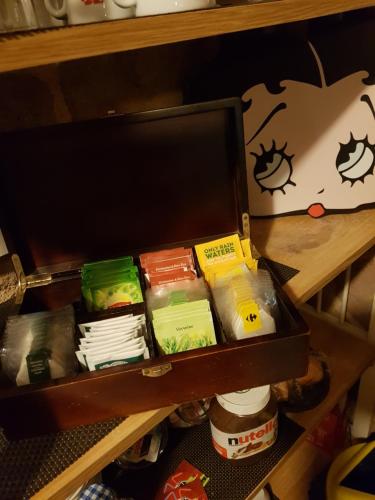 a box filled with different types of food on a shelf at Hotel des voyageurs Chez Betty in Neussargues-Moissac
