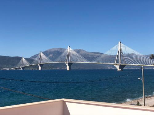 a bridge over a large body of water at Rio Beach Residence in Patra