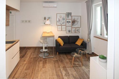 a living room with a couch and a table at Apartments Tessera in Split
