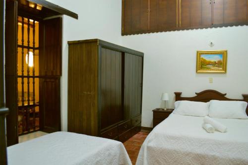 Ένα ή περισσότερα κρεβάτια σε δωμάτιο στο Hotel Casa Claustro De Zapatoca