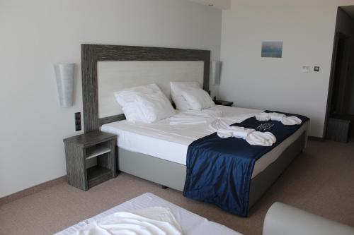 a bedroom with two beds with towels on them at Moonlight Hotel - All Inclusive in Sveti Vlas