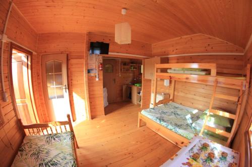 an inside view of a cabin with a bed at Słoneczna Polana in Solina