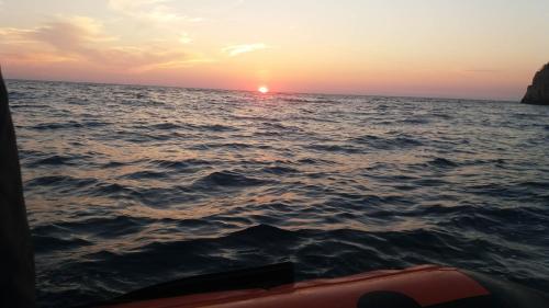 a sunset over the ocean from a boat at Darinka in Ulcinj