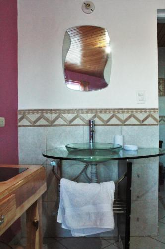a bathroom with a sink and a mirror at Villas La Quinta in Creel