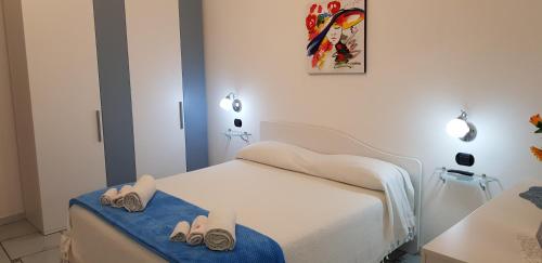 a bedroom with a bed with two pairs of slippers at Da Zia Pina in Minori
