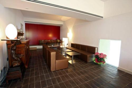 a living room with couches and a table and a couch at Hotel La Sosta in Cisano Bergamasco