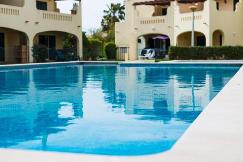 a swimming pool in front of a house at vilamaria apartment in Porches