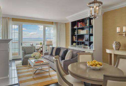 a living room with a couch and a table at Rosewood Miramar Beach in Santa Barbara