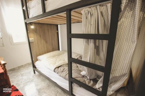 a couple of bunk beds in a room at Friends' Guesthouse & Hostel in Gjirokastër