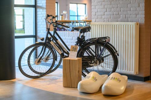 a bike is on display in a store with two bone shaped objects at Campanile Hotel & Restaurant Eindhoven in Eindhoven