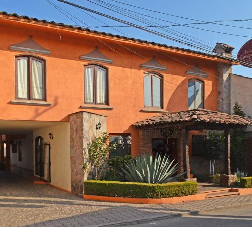 een oranje huis met een prieel ervoor bij Casa Grande in Zacatlán