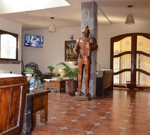 a statue of a man standing in a living room at Casa Grande in Zacatlán