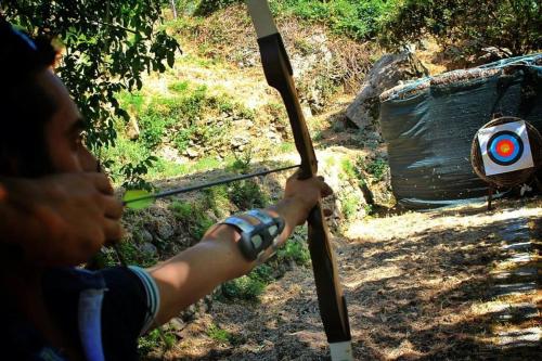 a young boy holding a spear and a target at Agriturismo San Cataldo in Motta Camastra