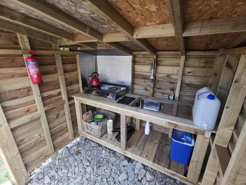 an overhead view of a kitchen in a log cabin at Syke Farm Campsite - Yurt's and Shepherds Hut in Buttermere