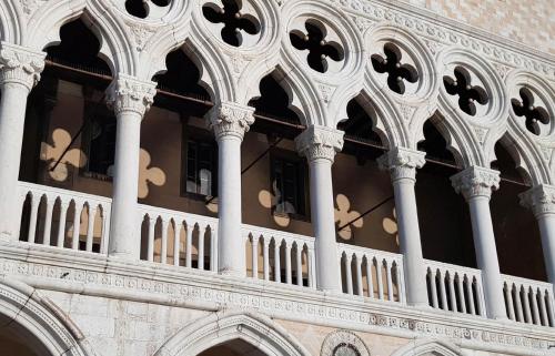 a building with a balcony with a bunch of clocks at Mariangela Artist's Lodge in Venice