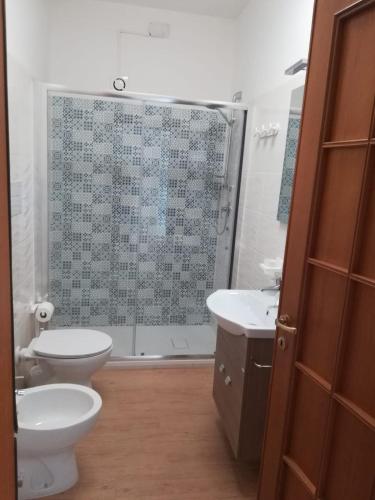 a bathroom with a toilet and a sink and a shower at IL CONTE DI MARRAONE in Agnone