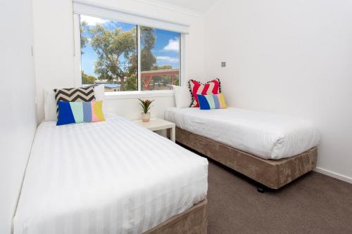 a bedroom with two beds and a window at BIG4 Anglesea Holiday Park in Anglesea