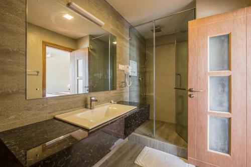 a bathroom with a sink and a mirror at Twenty-Two Weligambay in Weligama