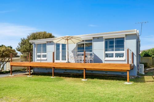 a house with a large wooden deck in front of it at Salomon Sea Haus - Sellicks Beach - C21 SouthCoast Holidays in Sellicks Beach