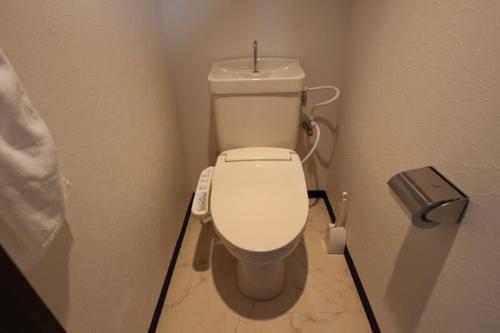 a small bathroom with a toilet in a stall at La Foret Fujimi in Hiroshima