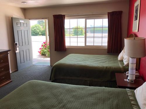 a hotel room with two beds and a window at Dixon Motel in Dixon