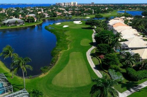 an aerial view of a golf course with a lake at Deluxe Coastal Home & Award-winning Golf in Whangaparaoa