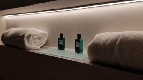 a bathroom with two bottles of soap and a towel at Hotel Garden Riviera in Santa Maria di Castellabate