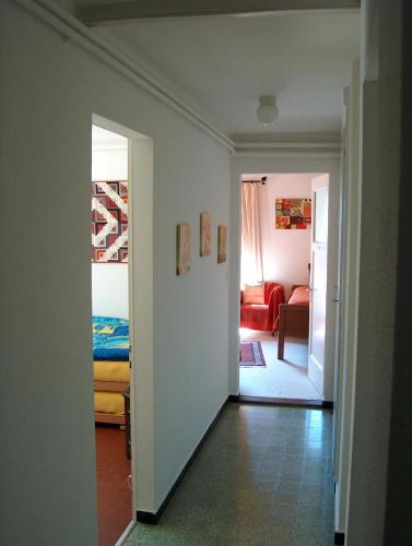 a hallway with a bedroom and a living room at Appartement La Coudraie in Blonay