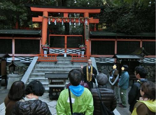 a group of people standing in front of a shrine at Koyasan Shukubo Sainanin in Koyasan
