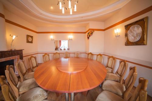 a dining room table with chairs around it at Hotel Vinnytsia Sawoy in Vinnytsya