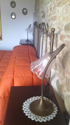 a lamp sitting on a table next to a bed at Antica Interamnia in Teramo