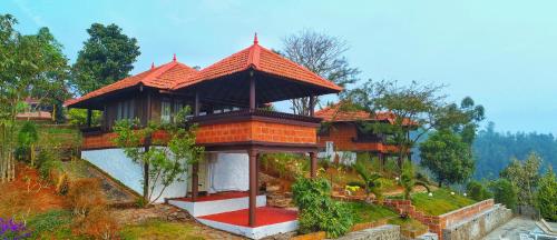a building with a roof on a hill at CONTOUR ISLAND RESORT & SPA , wayanad in Tariyod