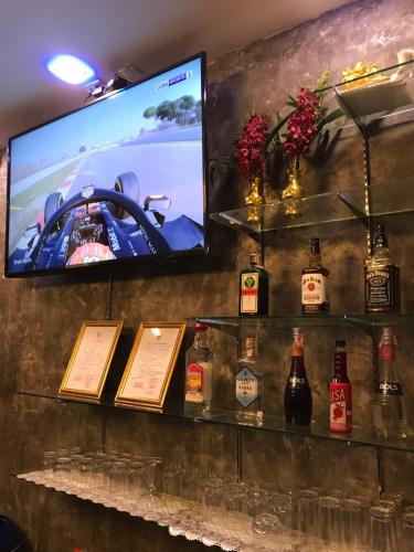 a bar with bottles of alcohol and a tv at You Place in Pattaya