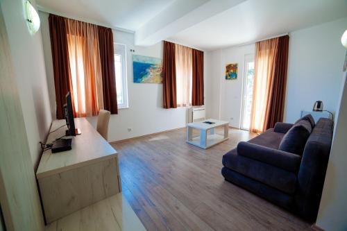 a living room with a couch and a tv at Apartments Art in Ulcinj